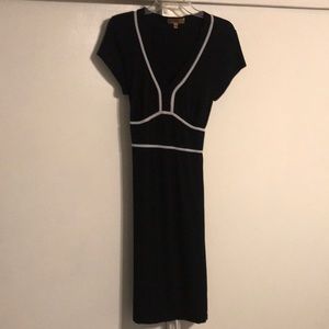 Black and white shirt-sleeved dress, with a tie in the back